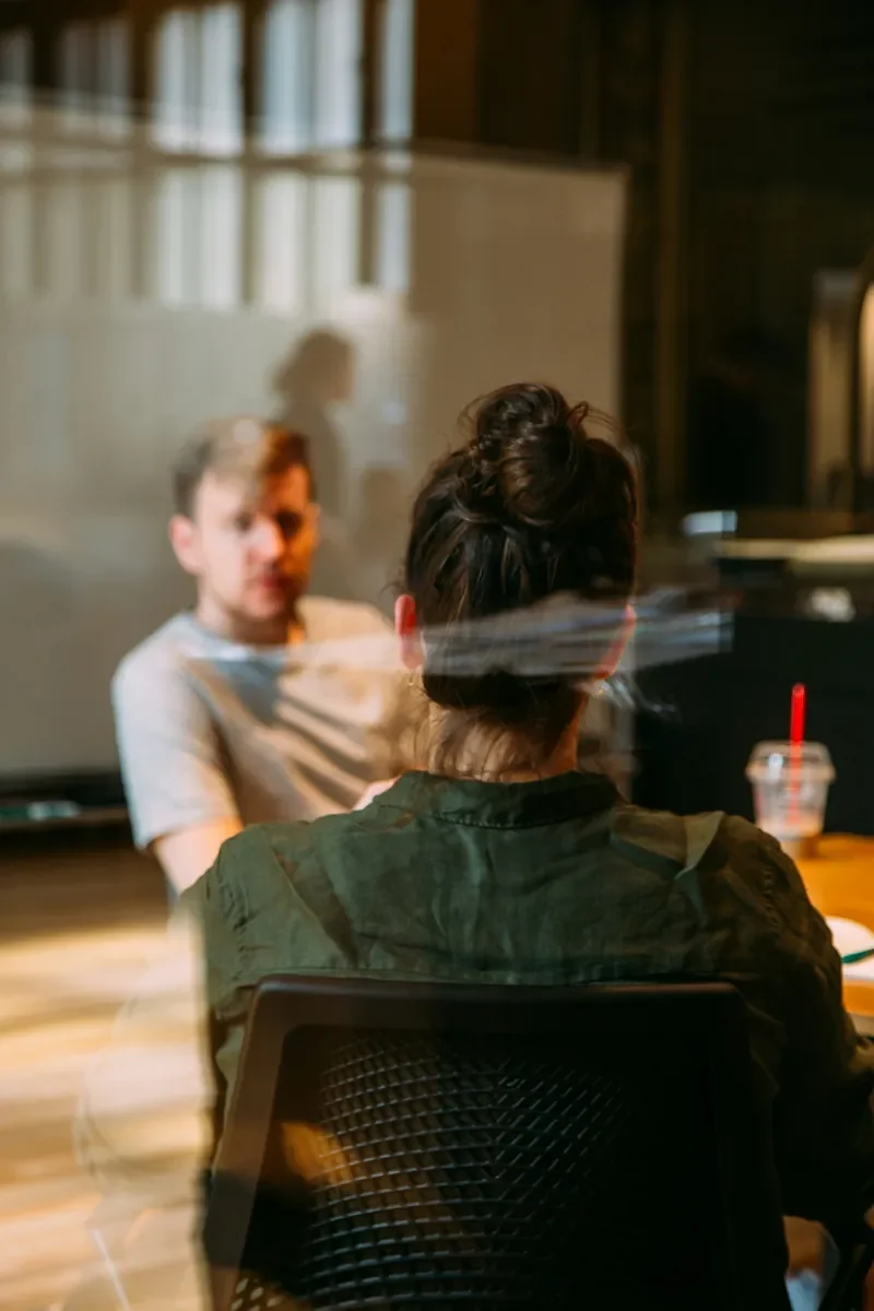 Two colleagues talking across a table