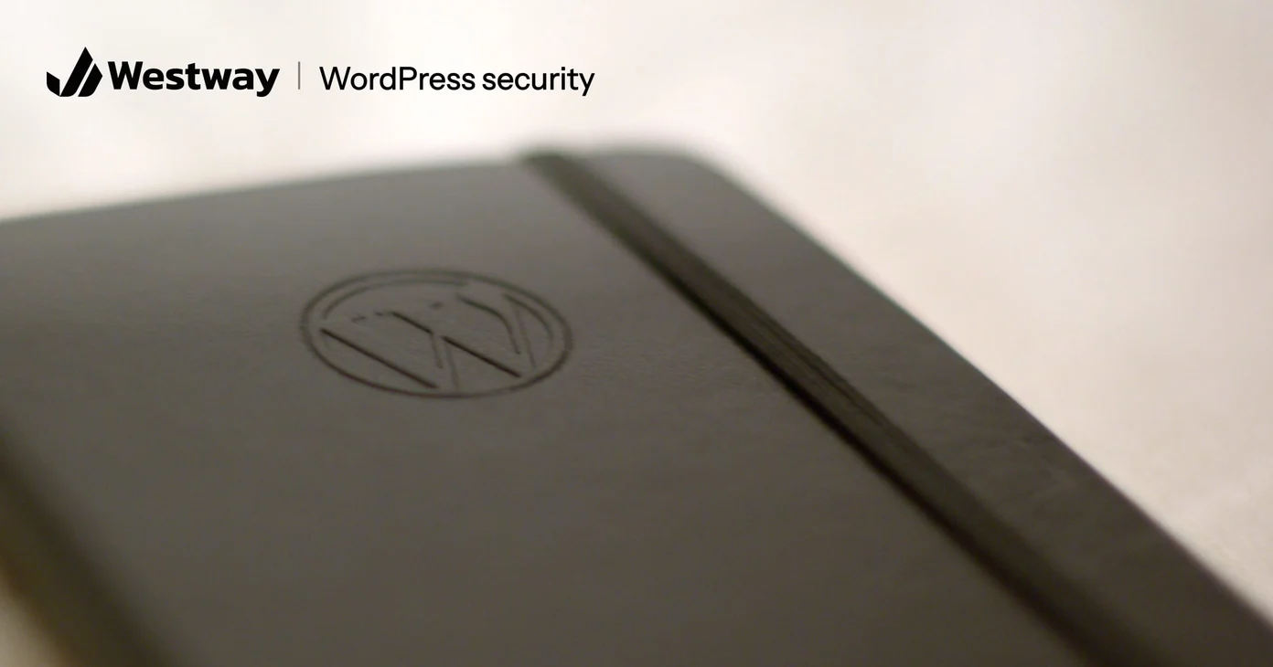 A black notebook embossed with the WordPress logo