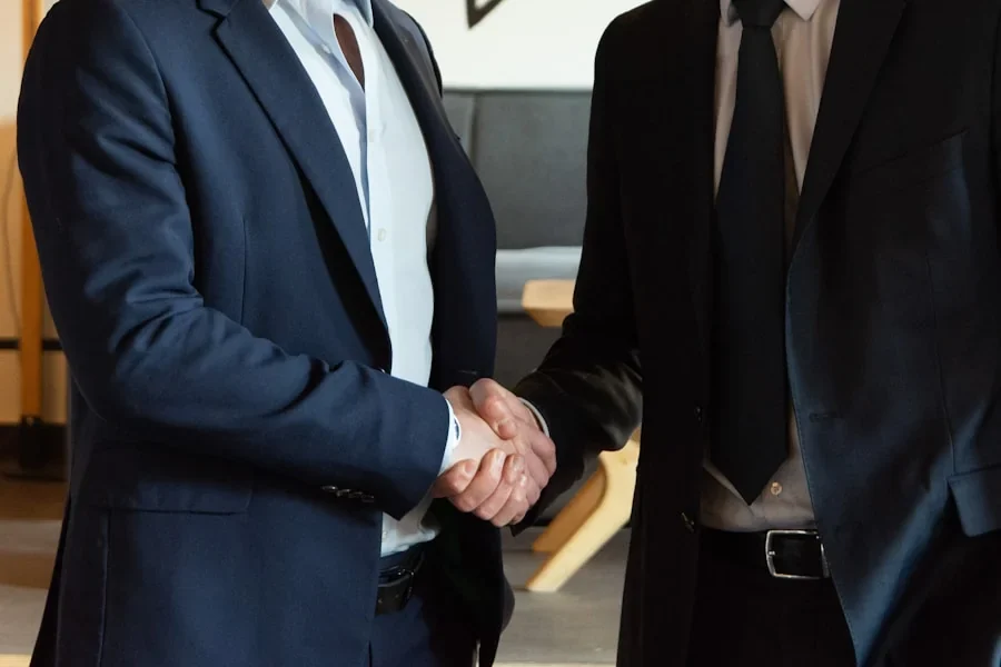 Two people in suits shaking hands